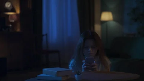 Afraid young girl with baseball bat standing near the window, runs to the table Stock Footage 250452445
