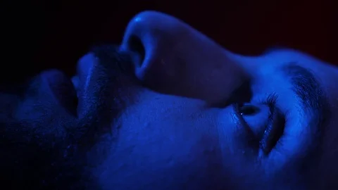 Afraid young man wakes up in bed at night. Nightmares, fear Stock Footage 103484312