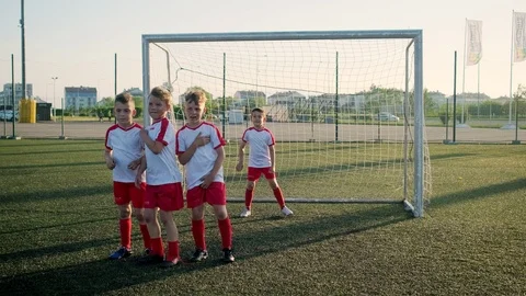 Afraid young players arrange wall goalkeeper misses ball Stock-Footage 115427995