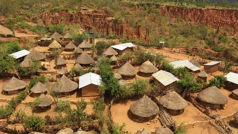 Africa rural natural landscapes - flying over traditional huts in village Stock Footage