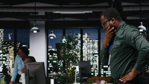African american advisor focusing on a complex problem in a dark office Stock Footage 318499728