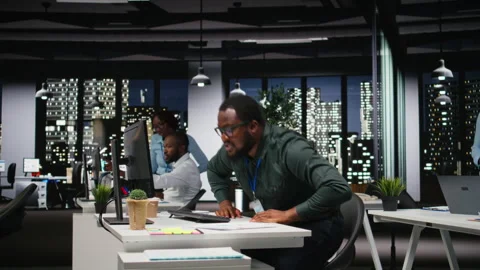 African american advisor focusing on a complex problem in a dark office Stock Footage 318565661