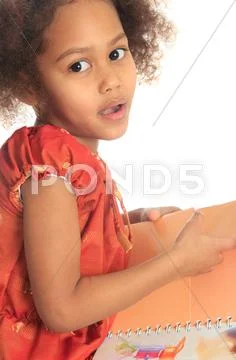 African american asian black child reads a book isolated metisse Stock Photos