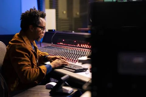 African american audio technician adding sound effects on recordings Fotos de archivo