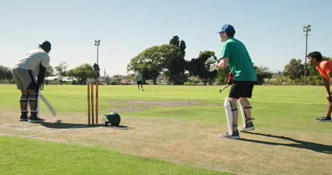 African american batsman tapping bat on pitch triggers keeper catching ball, Video stock 337159452