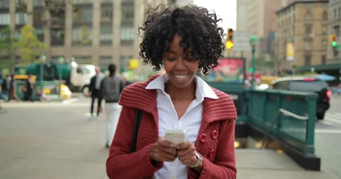 African American black woman in city walking texting smart phone cellphone 4k Stock Footage