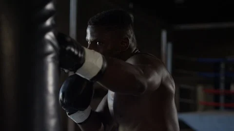 African American boxer throws combinations at heavy bag in slow motion Stock-Footage 124562637