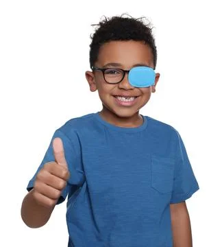 African American boy with eye patch on glasses showing thumb up against whi.. Fotos de archivo