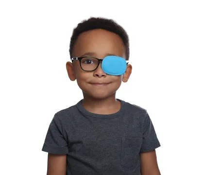African American boy with eye patch on glasses against white background. St.. Stock Photos