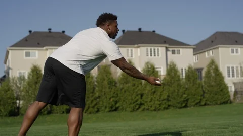 African american boy learning to play catch with dad Stock Footage 89900331