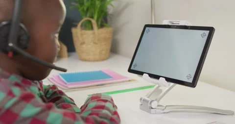 African american boy sitting at table and having video call Stock Footage 335682515