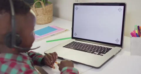 African american boy sitting at table and having video call Stock Footage 339320112