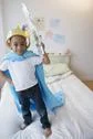 African American Boy Wearing Costume On Bed Stock Photos