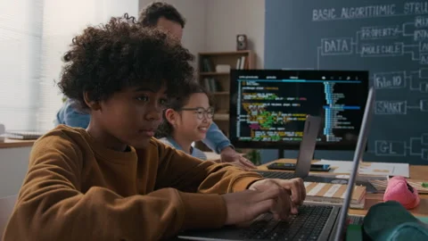 African American Boy Working on Problem on Laptop in Programming Class Stock Footage 306932362