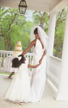 African american bride dancing with flower girl Stock Photos