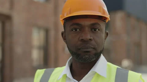 African american builder in helmet posing outdoors Stock Footage 196181154