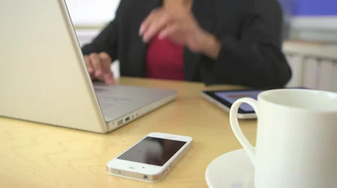 African American business woman picking up cell phone while working Stock Footage