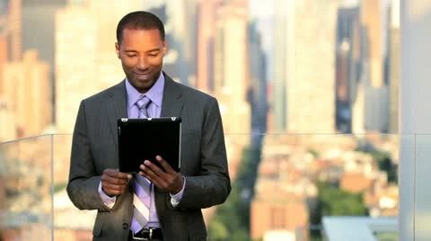 African American businessman closing contract online on touch screen on rooftop Stock Footage