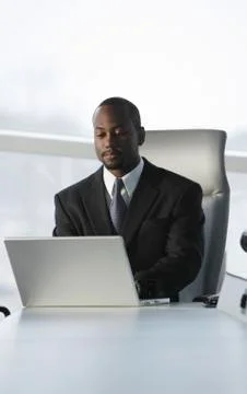 African American businessman typing on laptop Stock Photos
