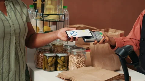 African american buyer using nfc payment at pos Stock Footage 262380003