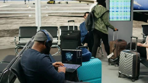 African american casual man using AI neural networks in airport lounge Stock Footage 339643110
