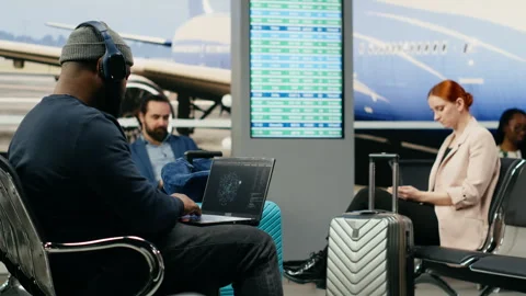 African american casual man using AI neural networks in airport lounge Stock Footage 339644188