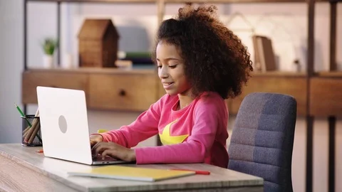 African american child doing homework on laptop Stock Footage