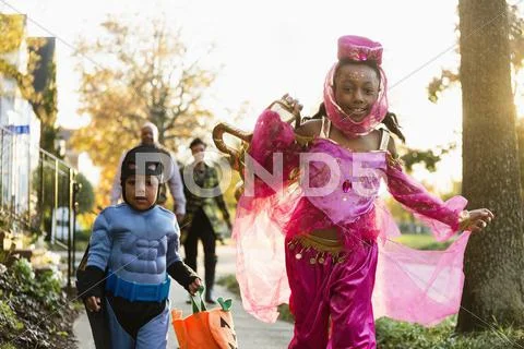 African American Children Trick-Or-Treating On Halloween