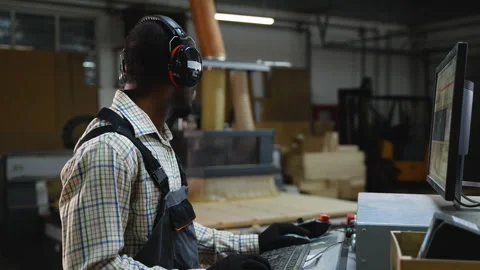 African American CNC Operator Programs Wood Cutting Machine Stock Footage 305605755