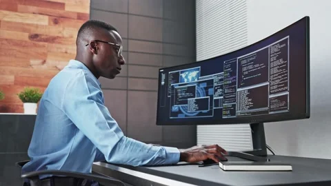 African American Coder Using Computer At Desk Stock Footage 220896923