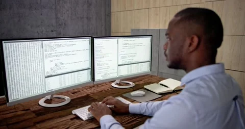 African American Coder Using Computer At Desk Stock Footage 230065995