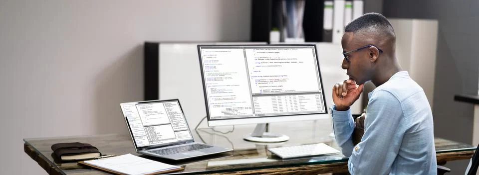 African American Coder Using Computer At Desk Stock Photos