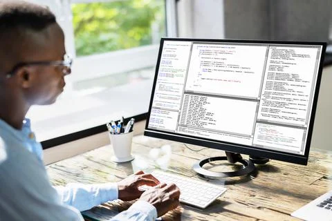 African American Coder Using Computer At Desk Foto stock