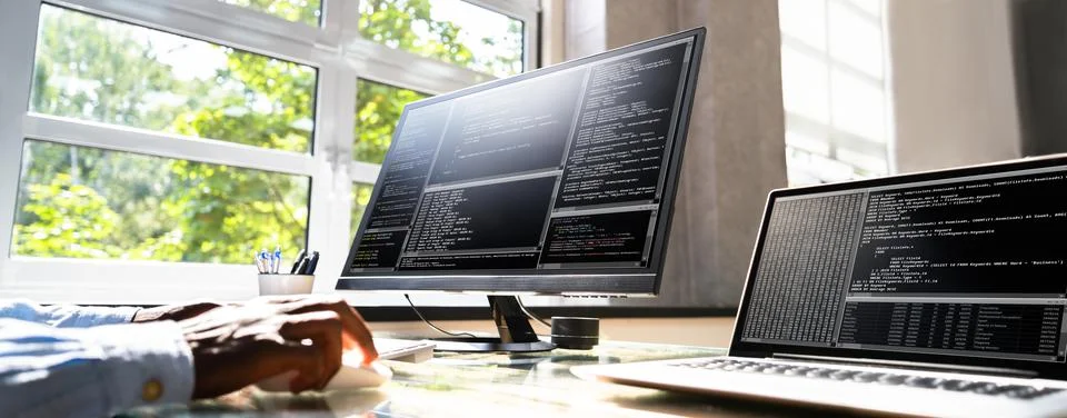 African American Coder Using Computer At Desk Stock-Fotos