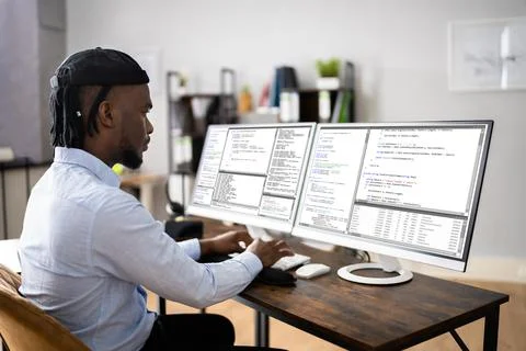 African American Coder Using Computer At Desk 写真素材
