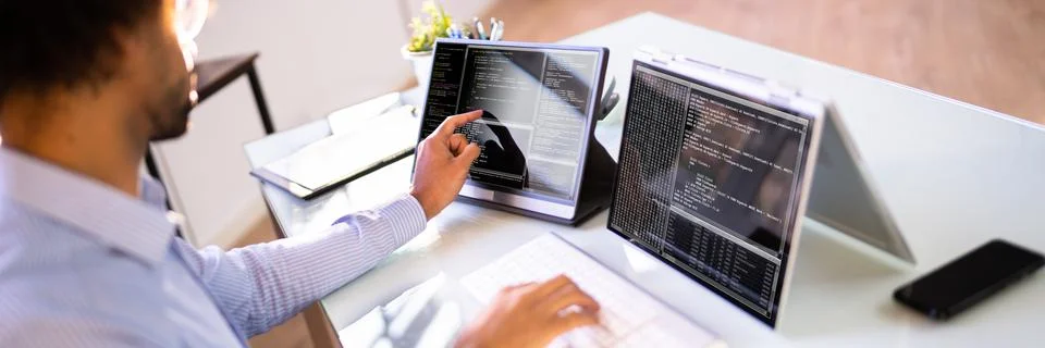 African American Coder Using Computer At Desk Stock-Fotos