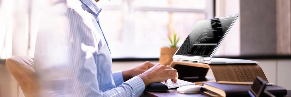 African American Coder Using Computer At Desk Stock-Fotos