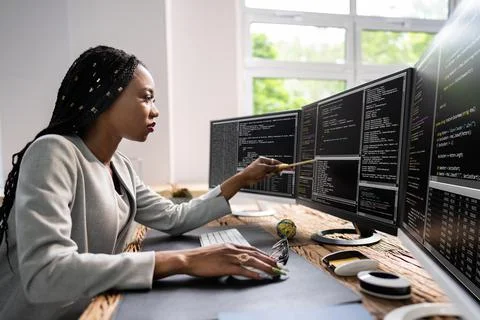 African American Coder Using Computer At Desk 写真素材