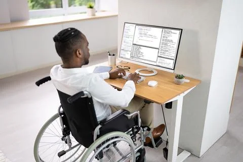 African American Coder Using Computer At Desk Stock-Fotos