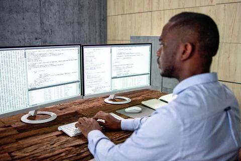 African American Coder Using Computer At Desk Foto stock