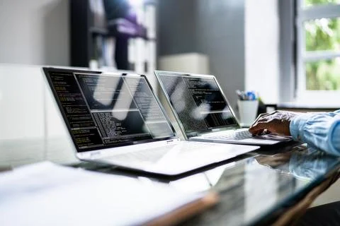 African American Coder Using Computer At Desk Stock-Fotos