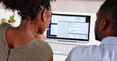 African American Coder Using Computer At Desk. Web Developer Stockfoto's