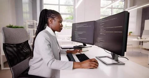 African American Coder Using Computer At Desk. Web Developer Lady 库存照片