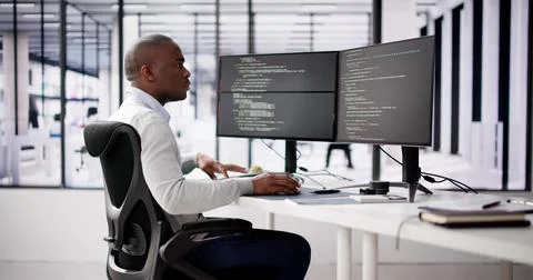 African American Coder Using Computer At Desk 스톡 사진