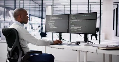 African American Coder Using Computer At Desk. Web Developer Stock Photos