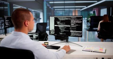 African American Coder Using Computer At Desk. Web Developer 库存照片