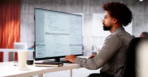 African American Coder Using Computer At Desk Stock Photos
