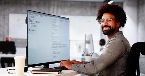 African American Coder Using Computer At Desk 写真素材