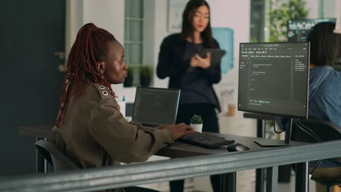 African american coder writing programming language on computer Stock Footage 231449104