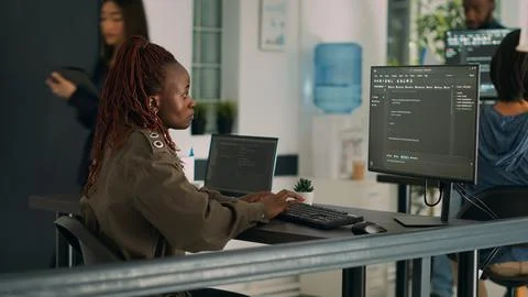 African american coder writing programming language on computer 库存照片